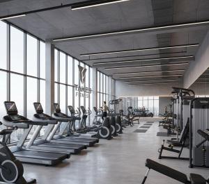 a gym with a lot of treadms and machines at Takes Antalya Luxury Hotel in Antalya