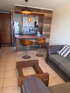 a living room with a couch and a table at Depto playa herradura in Coquimbo