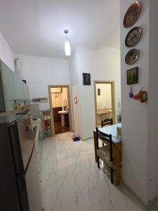 a kitchen and dining room with a table and a refrigerator at Lisi apartment in Tirana
