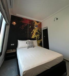 a bedroom with a bed with a cheetah pillow on it at Club Ébène Ouidah in Ouidah