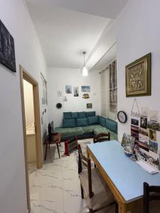 a living room with a blue couch and a table at Lisi apartment in Tirana