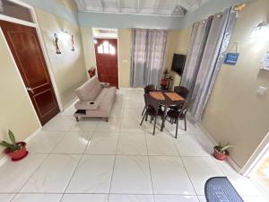 a living room with a couch and a table at C's Sunrise Escape in Roseau