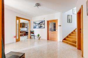 a living room with a staircase and a door at Vila Adalbert in Liberec