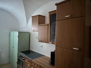 a kitchen with wooden cabinets and a stove at Sonilife Ferienwohnung Obervellach in Obervellach