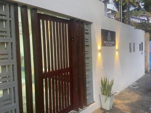 a wooden door with a gate in front of a building at Hotel Pousada Velas ao Mar in Maceió +11 photos