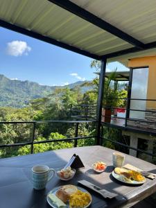 a table with plates of food on it with a view at Bellavista La Vega in La Vega