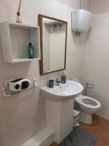 a bathroom with a sink and a toilet at Casa "La Fonte" in Spoleto