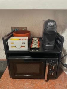 a black microwave sitting on top of a table at Casa "La Fonte" in Spoleto