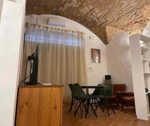 a dining room with a table and green chairs at Casa "La Fonte" in Spoleto +26 photos