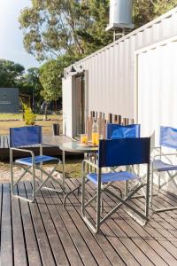 a table and chairs sitting on a deck at Container Los Lobos in Chapadmalal +7 photos