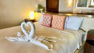 a bed with two swans made out of towels at Perfect Hideaway for Two-GroundFloor in La Majahua