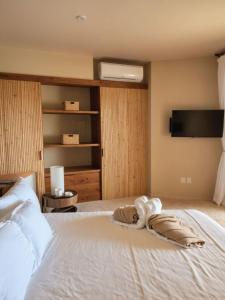 a bedroom with a white bed with a pillow on it at Perfect Hideaway for Two-GroundFloor in La Majahua