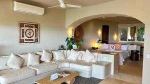 a living room with a white couch and a table at Perfect Hideaway for Two-GroundFloor in La Majahua