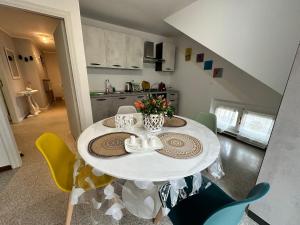 a dining room with a white table and chairs at ARIEL'S house in San Benedetto del Tronto