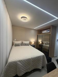 En eller flere senge i et værelse på Lindo Loft Studio no Centro de Curitiba