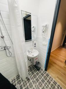 a bathroom with a sink and a mirror at Milano Apartment in Hamburg +17 photos
