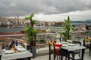a balcony with tables and chairs and a view of a city at Golden Horn Park Hotel in Istanbul