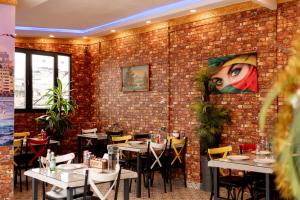 a restaurant with tables and a brick wall at Golden Horn Park Hotel in Istanbul