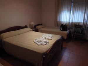 En eller flere senge i et værelse på Hotel vacacional Sierras de cordoba