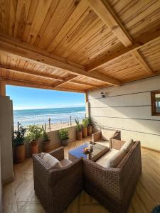 a living room with couches and a view of the beach at Deluxe Apartment At Amouage Anza in Agadir