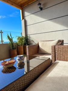 a table and chairs on a patio with a glass table at Deluxe Apartment At Amouage Anza in Agadir