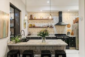 a kitchen with a counter with a sink and a stove at Escape to a Mountain Retreat in Beechmont, Australia in Beechmont