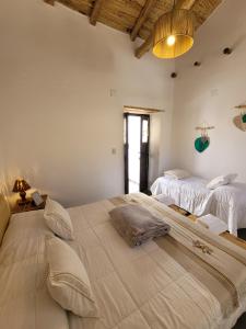 a bedroom with two large beds in a room at La Vieja Esquina in Cachí