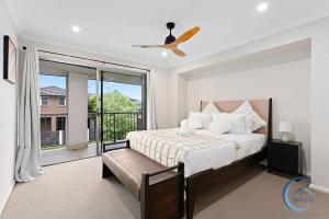 a bedroom with a bed and a large window at Cozy 4BR Family Haven Walk to Penrith CBD&Train in Penrith