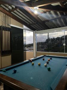 a pool table with balls on it in a room at Recanto familiar in Florianópolis