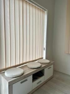 a bench with two pillows on it in a room at Apartment DUNJA 2 Laktasi in Laktaši