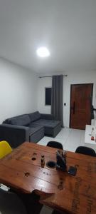 a living room with a couch and a table at Casa, Perto de Praias, Shoppings e Valparaíso in Maioba