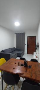 a living room with a wooden table and a couch at Casa, Perto de Praias, Shoppings e Valparaíso in Maioba +13 photos