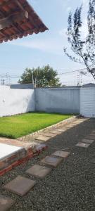 a backyard with a fence and a yard with grass at Casa, Perto de Praias, Shoppings e Valparaíso in Maioba