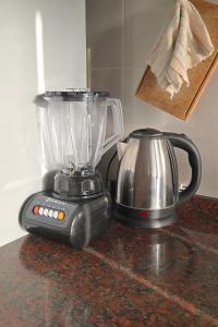 un frullatore appoggiato su un bancone accanto a un bollitore di Arcoiris Dptos a Paso de la Patria