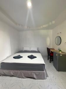 a bedroom with a bed and a desk and a table at Secret Lanta Guesthouse in Ko Lanta +22 photos