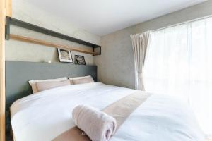 a bedroom with a white bed and a window at Cellar 88 in Sonogi