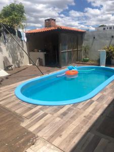 a large blue swimming pool on a wooden deck at pousada cardoso - casa 2 in São Gabriel