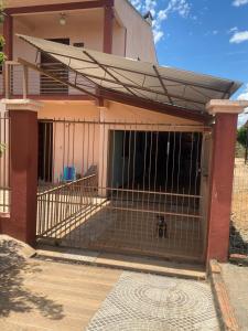 a dog in a cage in a house at pousada cardoso - casa 2 in São Gabriel