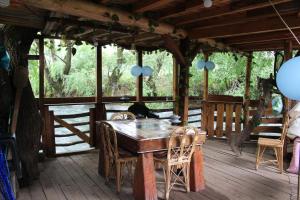 a wooden table and chairs on a deck at Mercadito de Pamela in Huépil