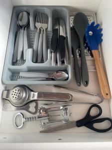 a drawer filled with lots of kitchen utensils at Apartamento beira-mar in Ilha Comprida