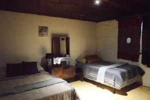 En eller flere senge i et værelse på Hostal y Restaurante Chilltepe Ataco