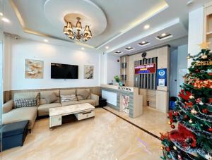 a living room with a christmas tree and a couch at Phương Châu Holiday Hotel Đà Lạt in Da Lat