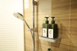 a bathroom with two soap bottles on a wall at 水と翠 in Gujo