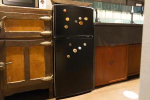 a black refrigerator in a kitchen next to a counter at 水と翠 in Gujo