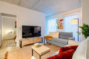 un soggiorno con un divano e una TV di Charming condo in Rosemont a Montréal