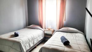 En eller flere senge i et værelse på Hospedaje Rincón del Sur 2