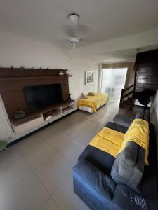 En eller flere senge i et værelse på Conforto, praticidade e bem-estar