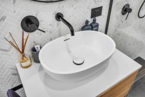 a white sink on a counter in a bathroom at Tathra Bermagui Road 613 in Tathra +16 photos
