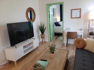 een woonkamer met een flatscreen-tv bij The Hamilton Elm in Teaneck