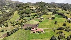 an aerial view of a house on a grassy hill at Finca el Paraíso de Monguí in Monguí